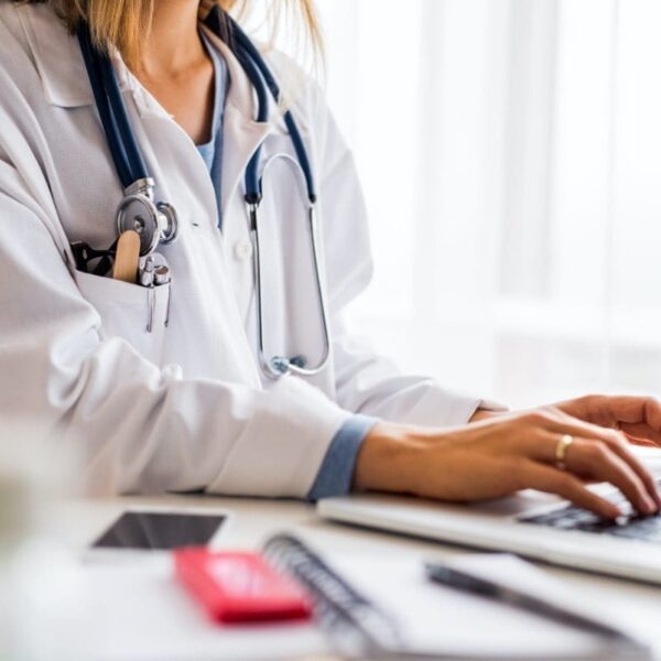 The Vaccine App Health Practitioner Working on their Laptop